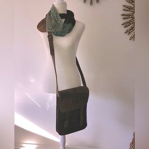 Unisex rugged leather messenger bag with branded horse emblem.